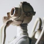 a closeup photo of a robot toy wearing a gas mask