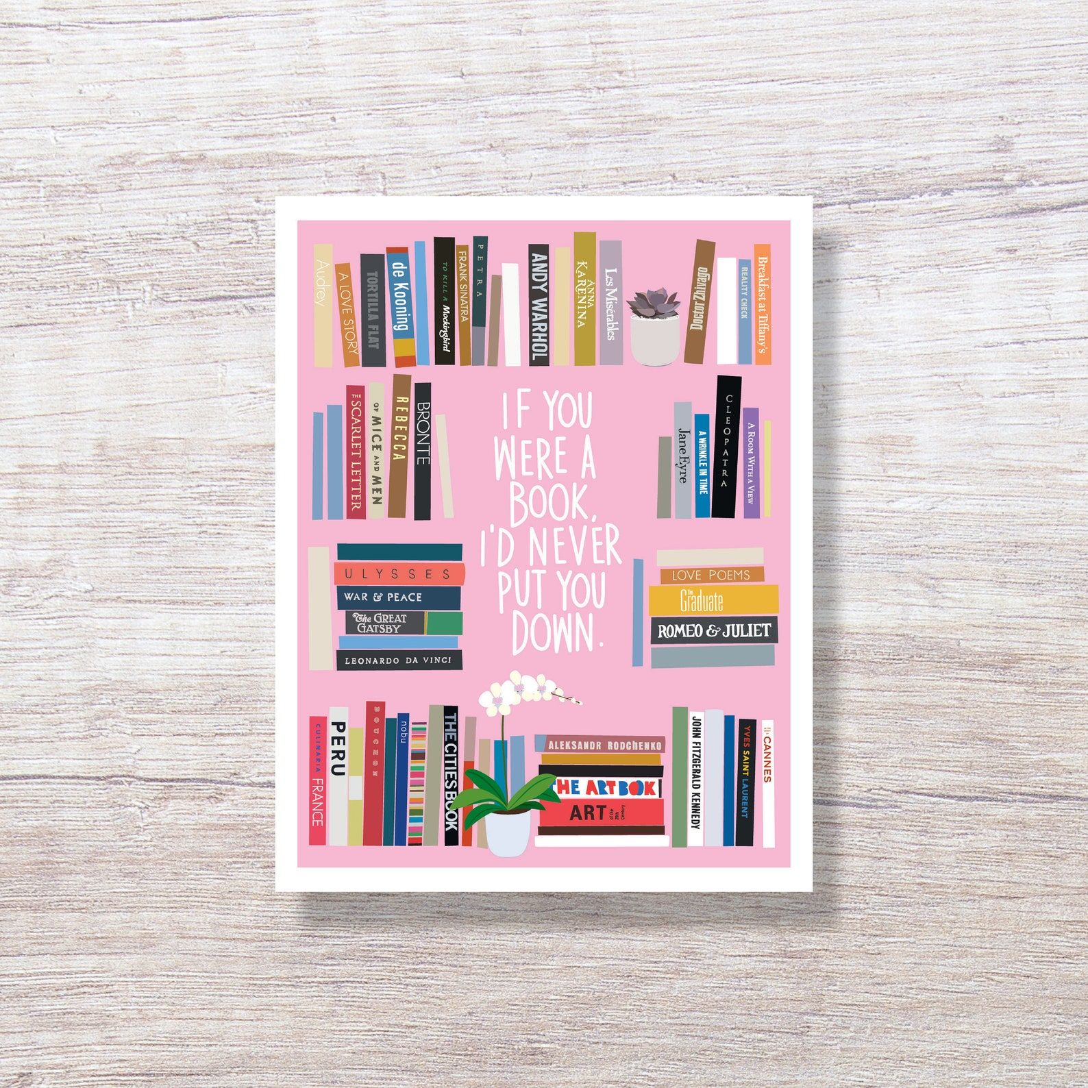a pink card with book stacks that reads "If you were a book, I'd never put you down"