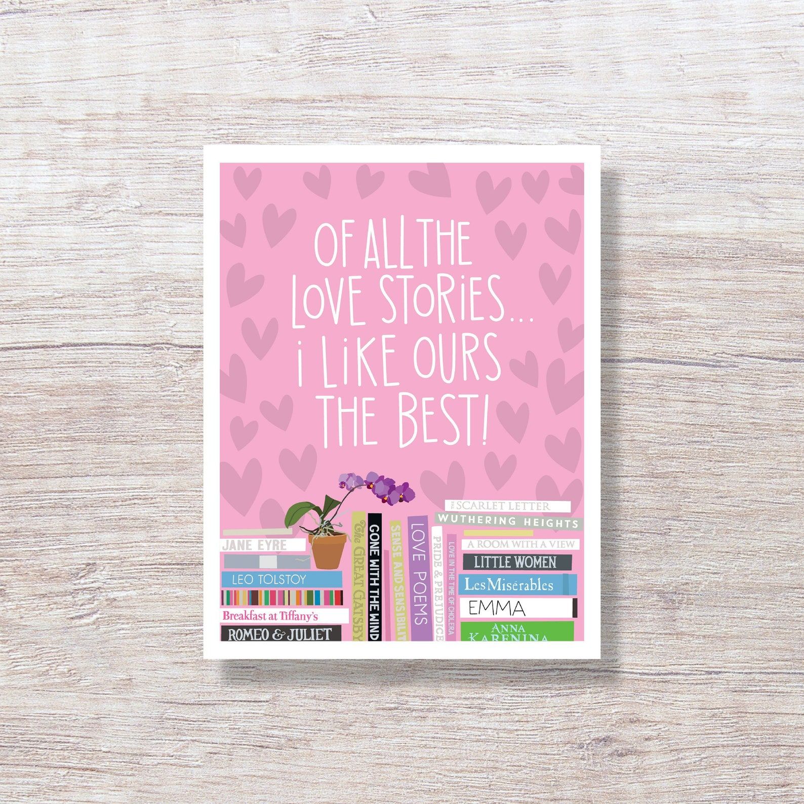 a pink card with stacks of romantic books that the words "Of all the love stories, I like ours the best"