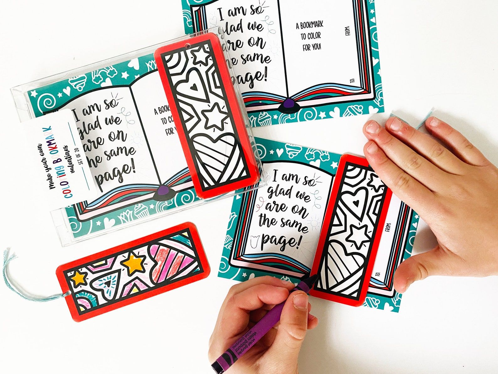 A teal, white, and red Valentine's Card that says "I am so glad we are on the same page" with a coloring bookmark attached