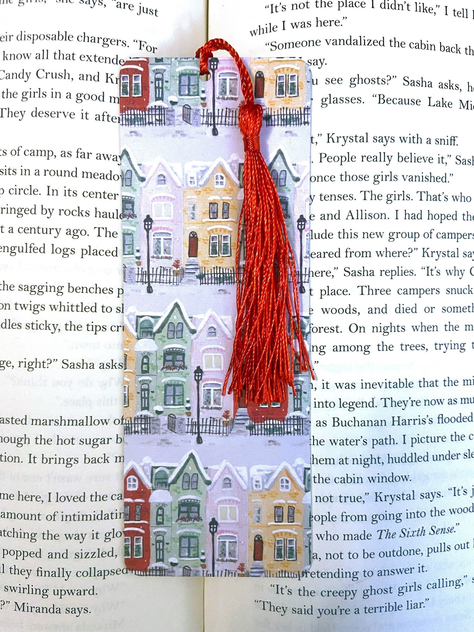 A snowy scene of colorful townhouses on a bookmark