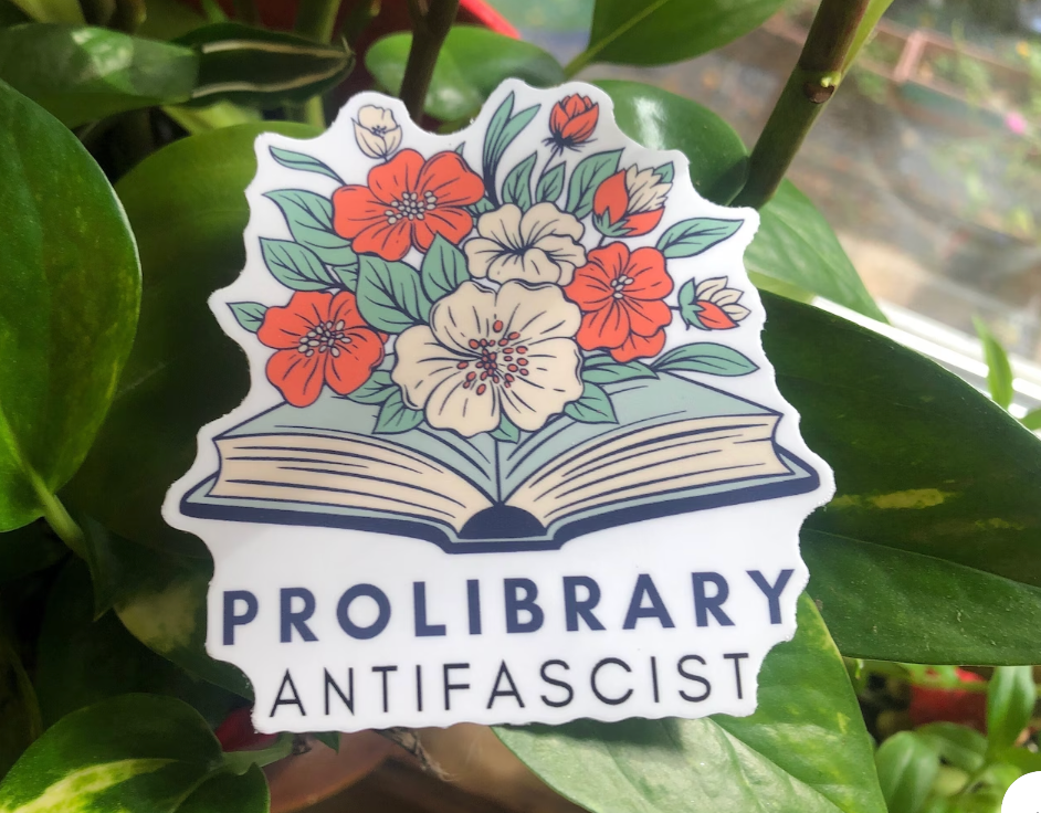 sticker with an open book and flowers coming out. it reads "prolibrary antifascist."