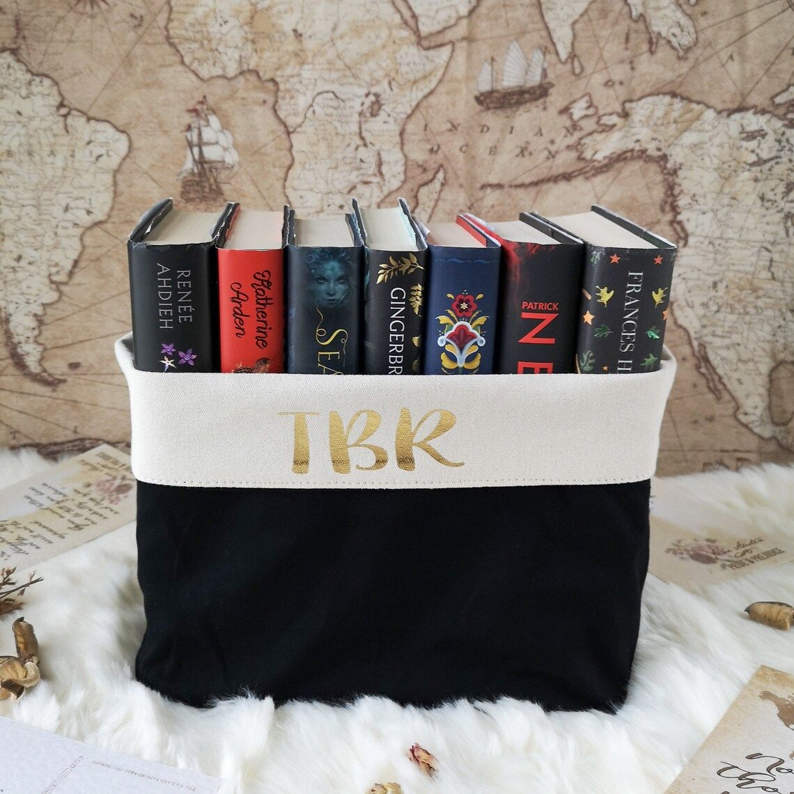 Canvas basket with TBR printed on side containing books