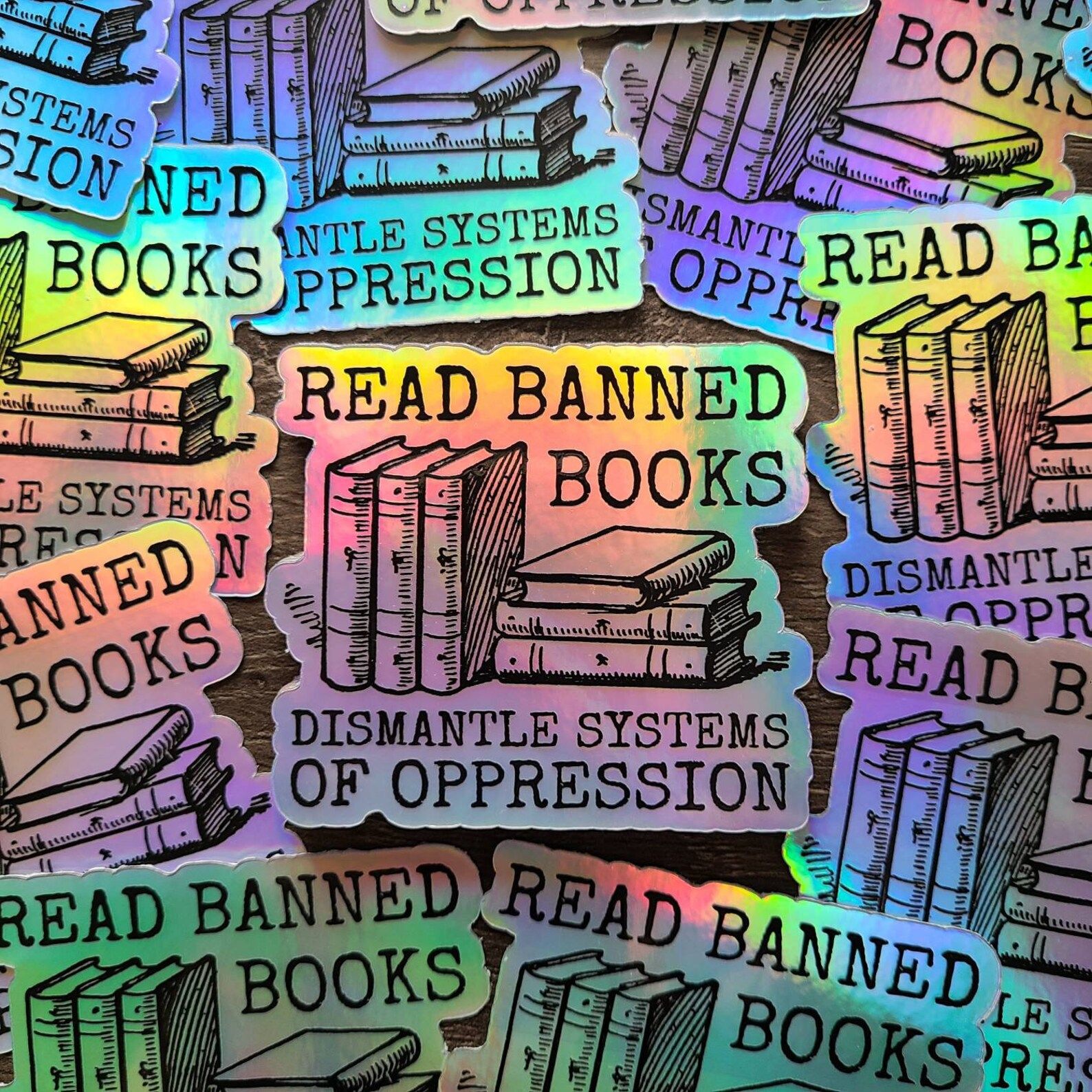holographic stickers that read "read banned books, dismantle systems of oppression."