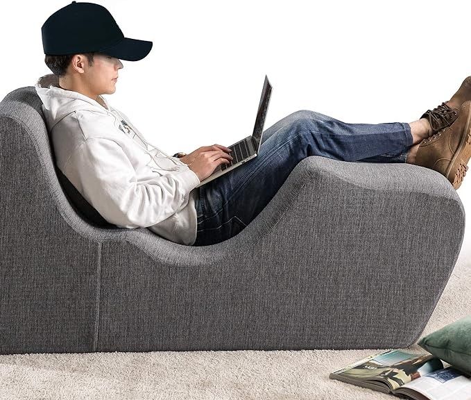 a man on his laptop sitting on a grey zero gravity chaise lounger