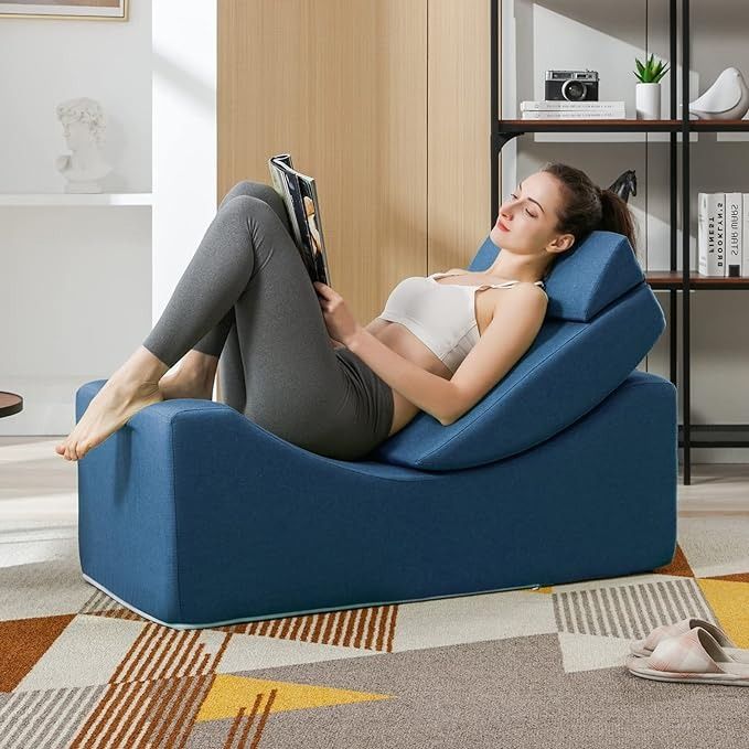 a person reading a magazine a small blue yoga chair