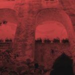 stone facade of Italian villa with a red filter applied