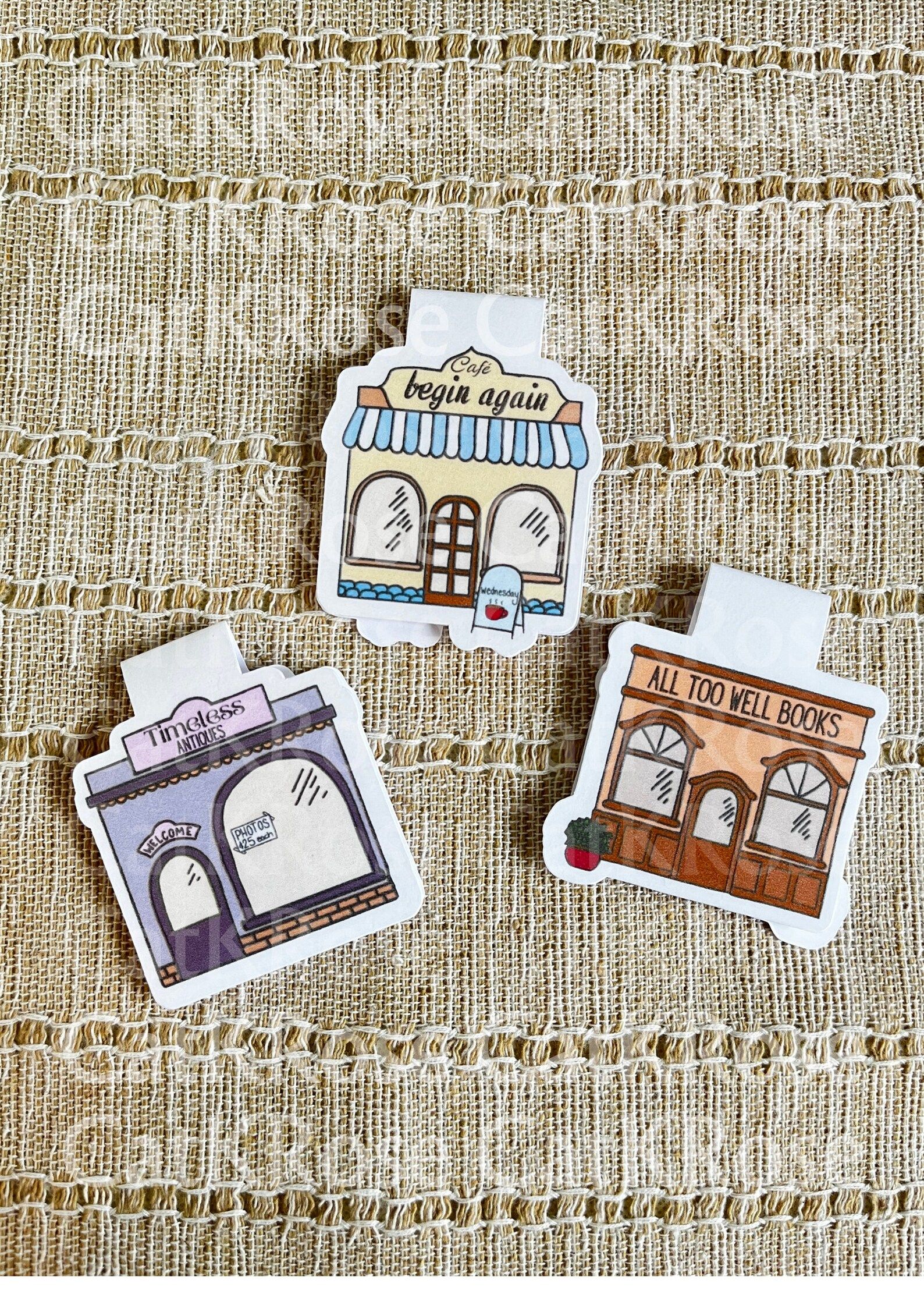 Set of three magnetic bookmarks in the shape of a bookstore, cafe, and antique store, all named after Taylor Swift songs. 