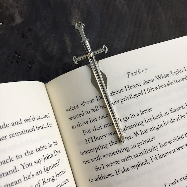 silver sword clip bookmark inside a book