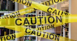 caution tape superimposed over library shelves