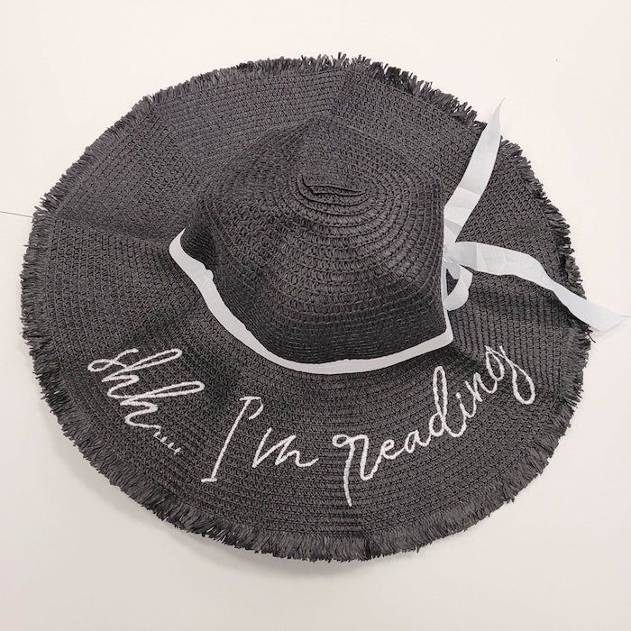 gray sunhat with the words "shh... I'm reading" embroidered on the brim