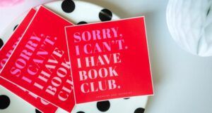 stack of red enamel stickers with text that reads "sorry I can't, I have book club"