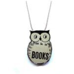 image of a necklace that is in the shape of an owl. on the owl's chest is the word books.