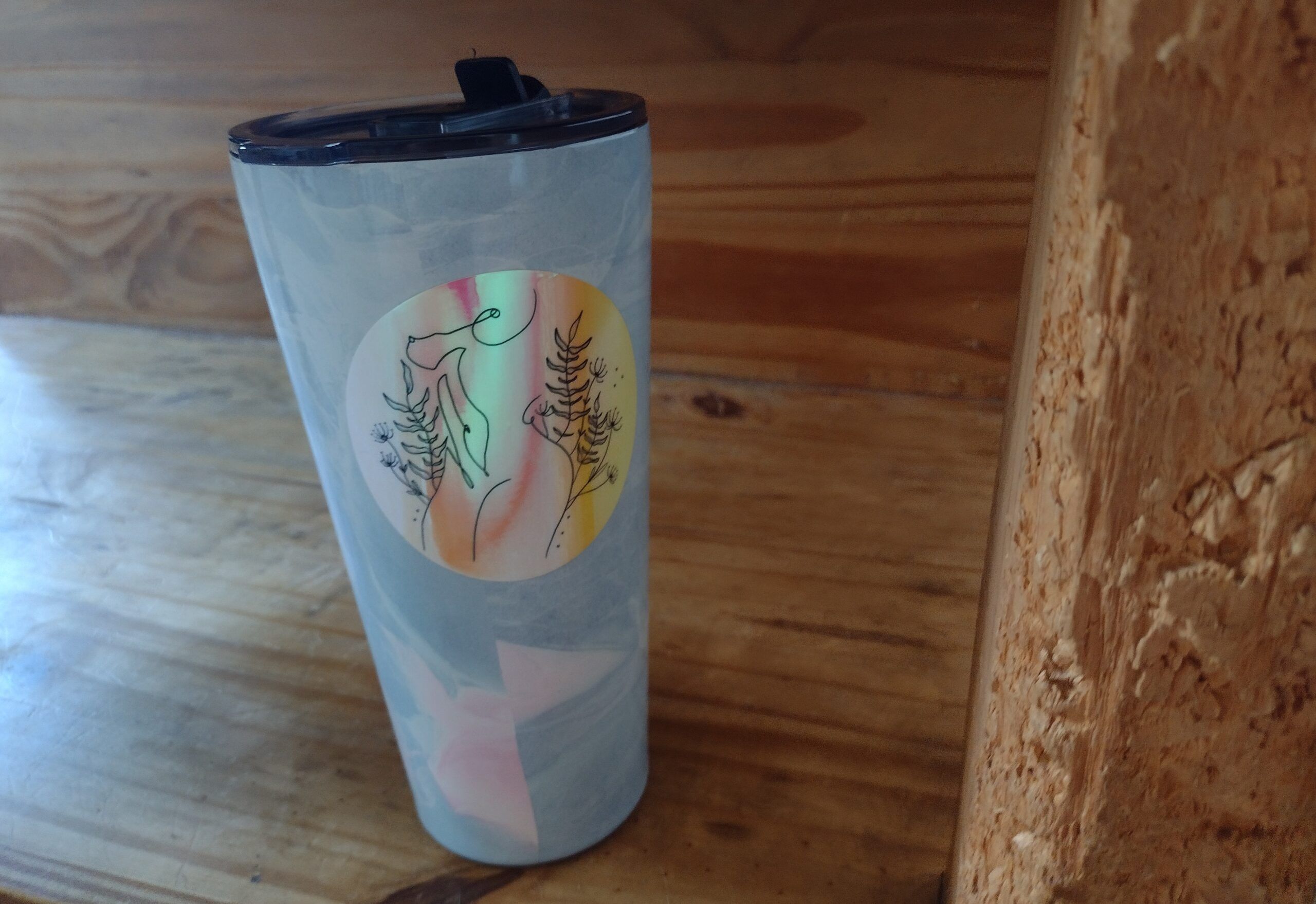 a water bottle beside a chewed-up wooden coffee table leg