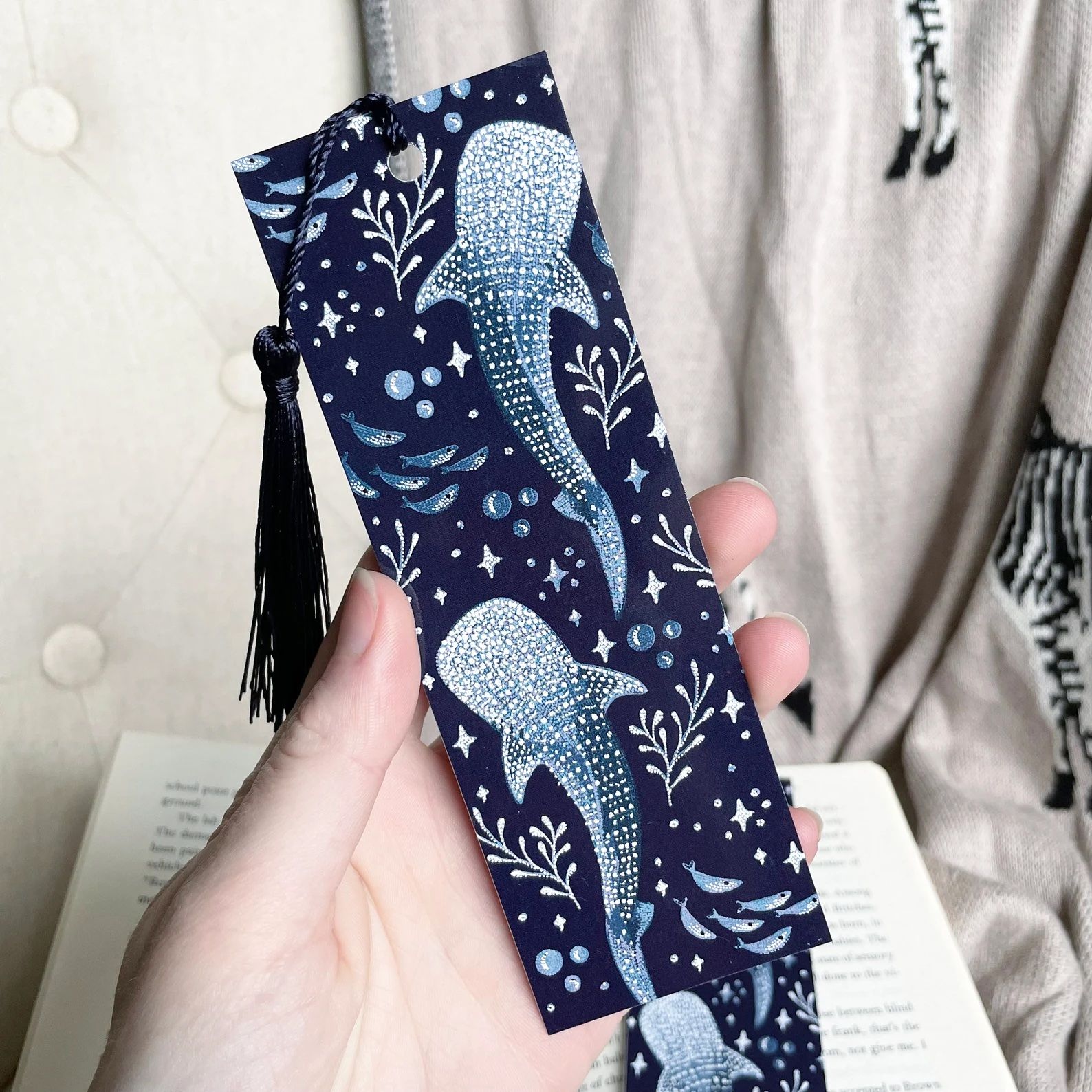 a photo of a dark blue bookmarks featuring illustrations go whale sharks