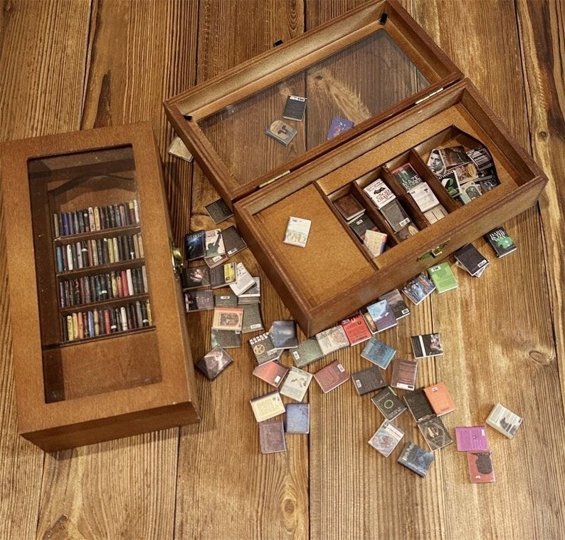 a mini bookcase with a glass cover