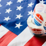 a roll of "I voted today" stickers on an American flag